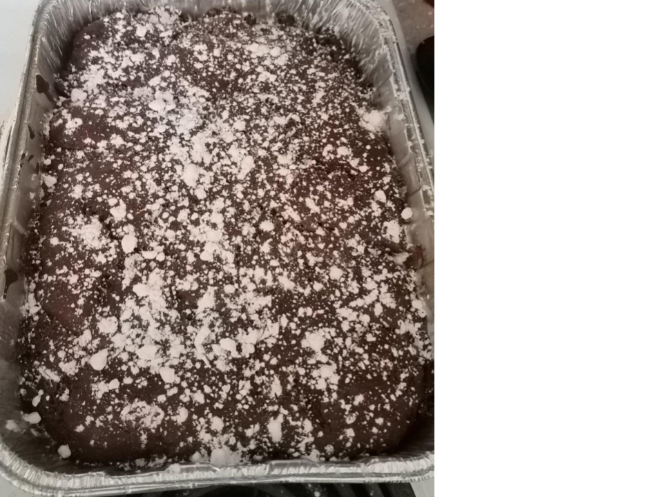 A tray of brownies dusted with powdered sugar